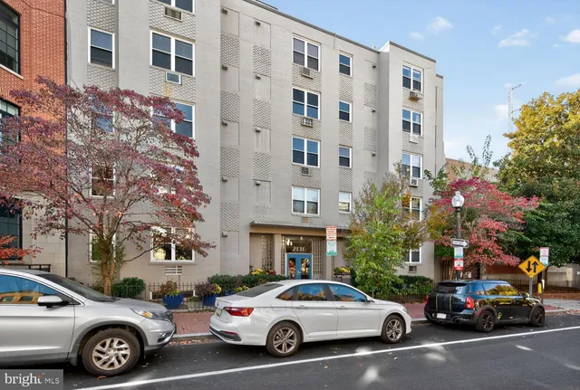 a view of a cars park in front of a building