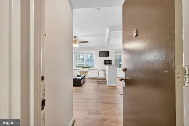 a view of living room with furniture and a view of bathroom