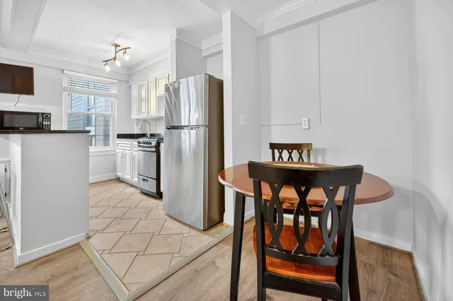 a kitchen with stainless steel appliances a refrigerator and a stove top oven