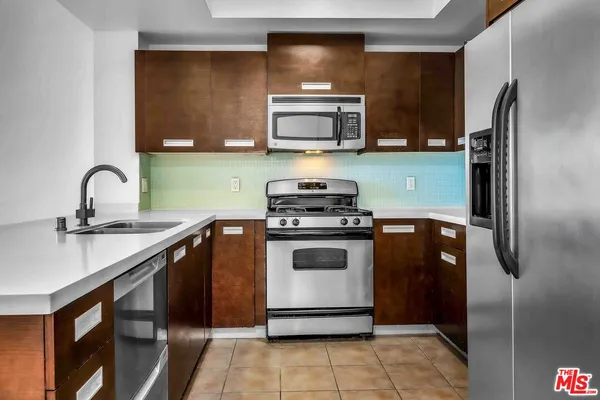 a kitchen with a refrigerator sink and stove