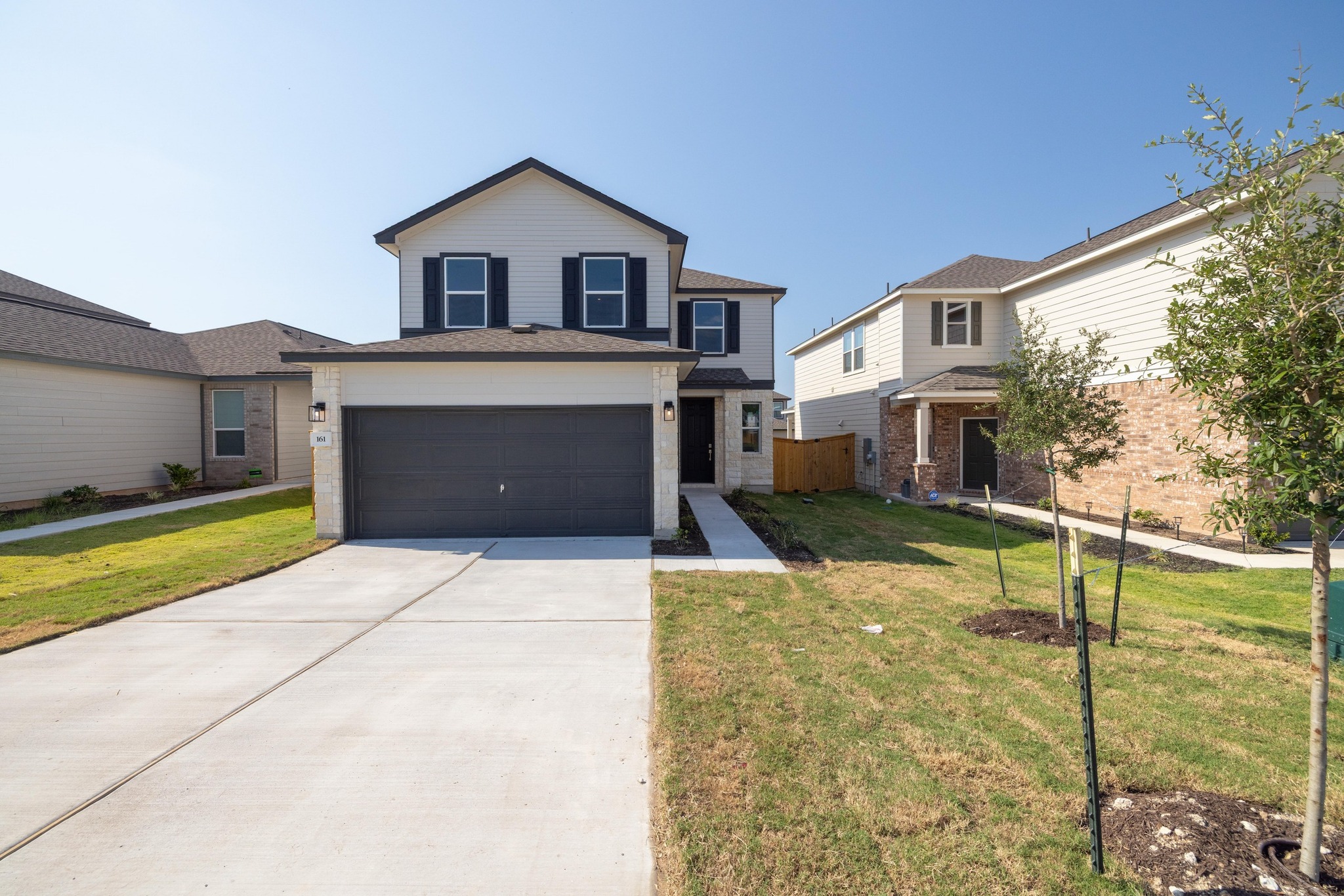 a front view of a house with a yard