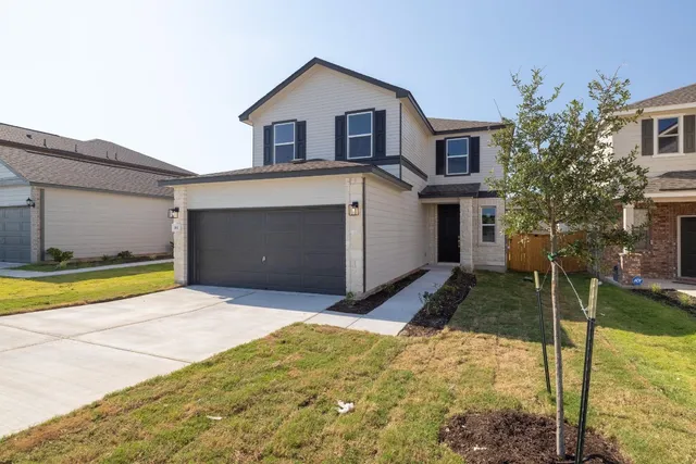 a front view of a house with a yard