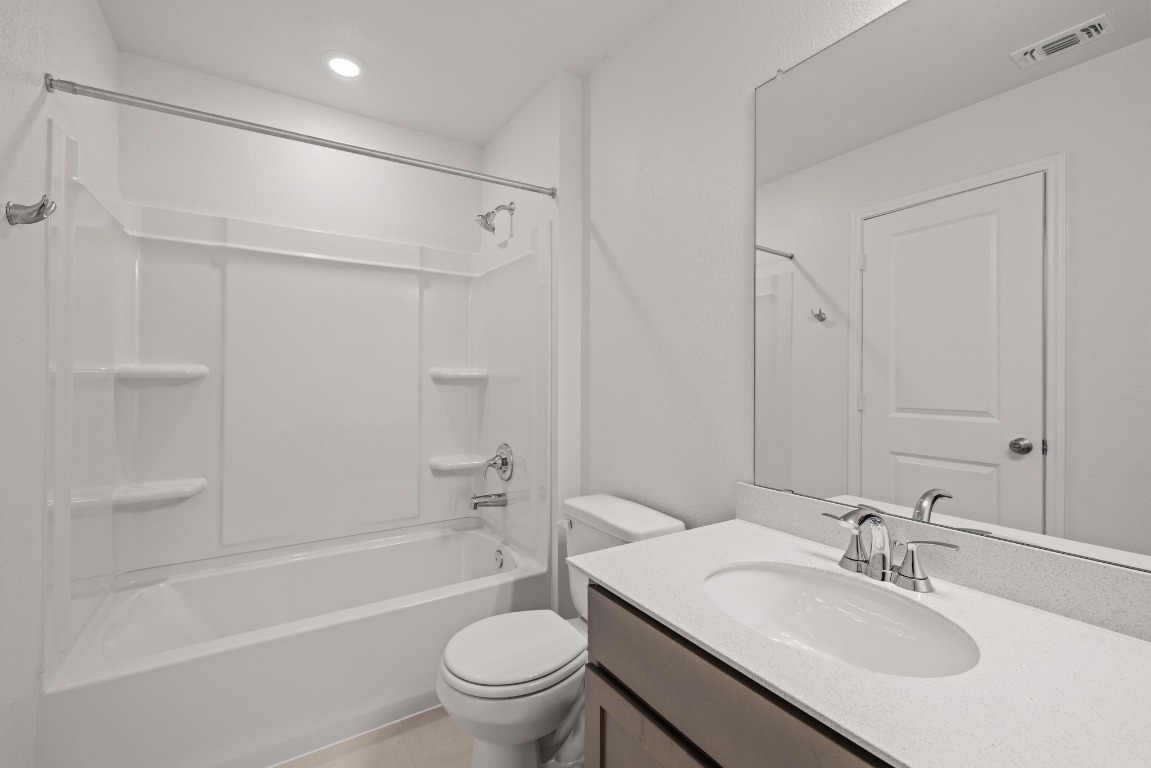 161 Lucky Texan Road Jarrell, TX 76537 - Photo 25 of 32 a bathroom with a sink toilet and a bathtub