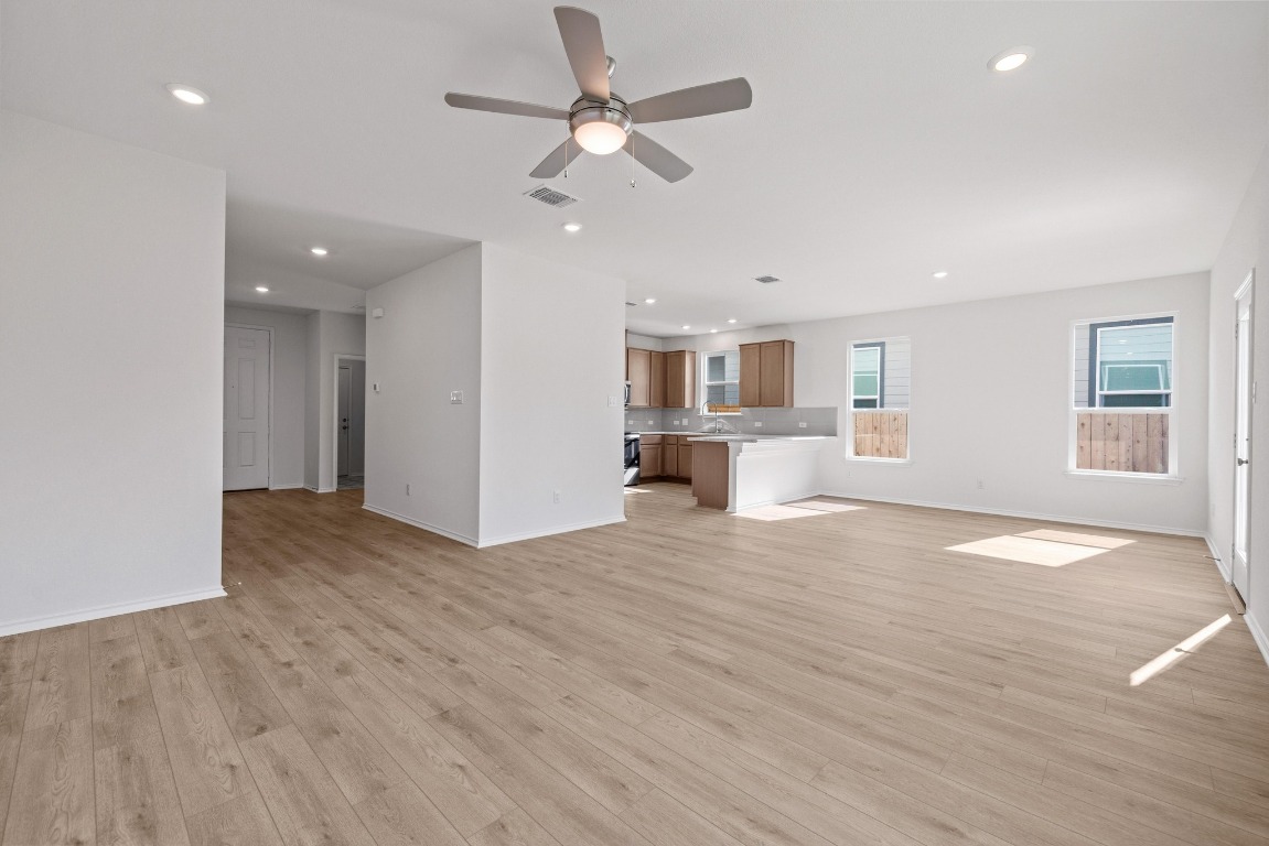 161 Lucky Texan Road Jarrell, TX 76537 - Photo 5 of 32 an empty room with wooden floor and windows