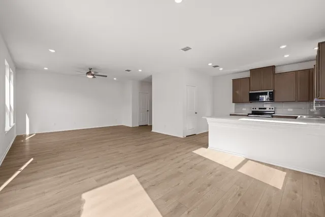 a view of kitchen with microwave and cabinets