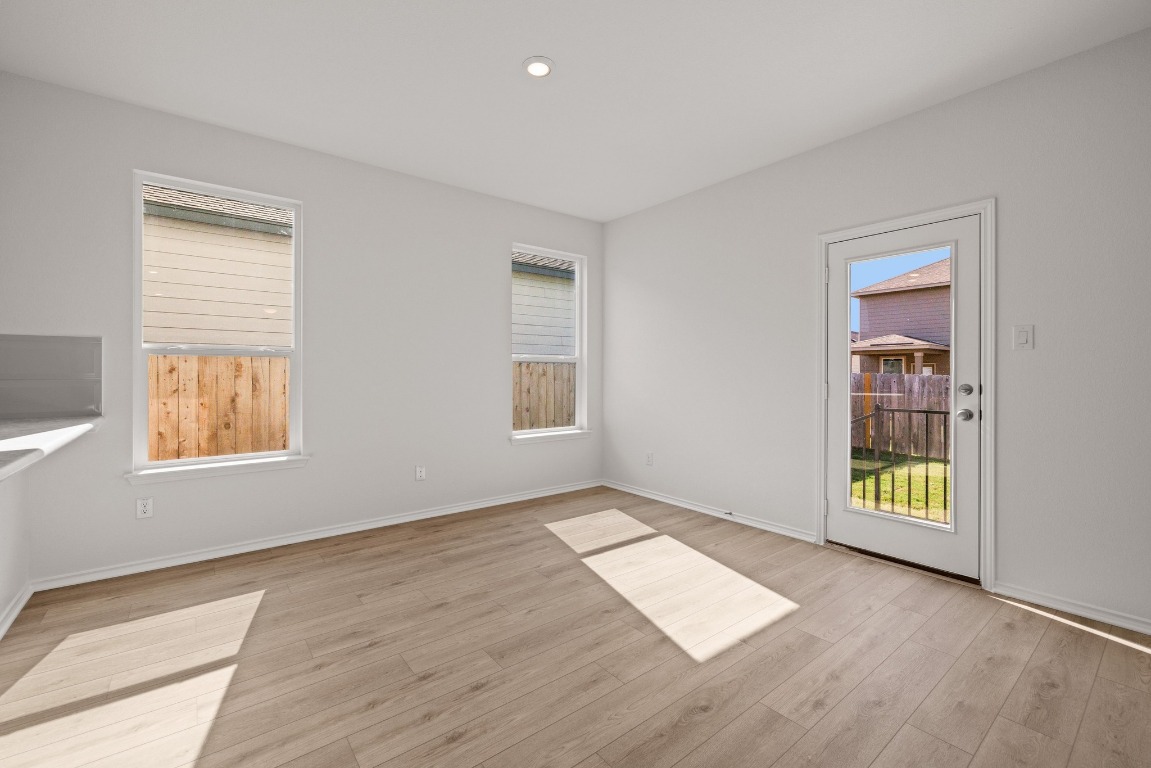 161 Lucky Texan Road Jarrell, TX 76537 - Photo 8 of 32 an empty room with wooden floor and windows