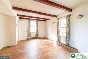 a view of a utility room with wooden floor