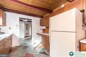a kitchen with a stove a refrigerator and a sink