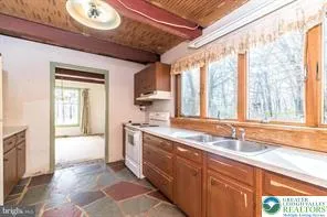 a spacious bathroom with a granite countertop sink and a large mirror