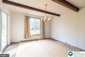 a view of empty room with fireplace and window