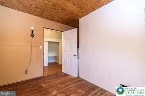 a view of entryway with wooden floor and furniture