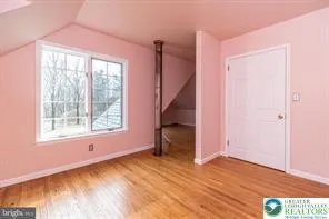 an empty room with wooden floor