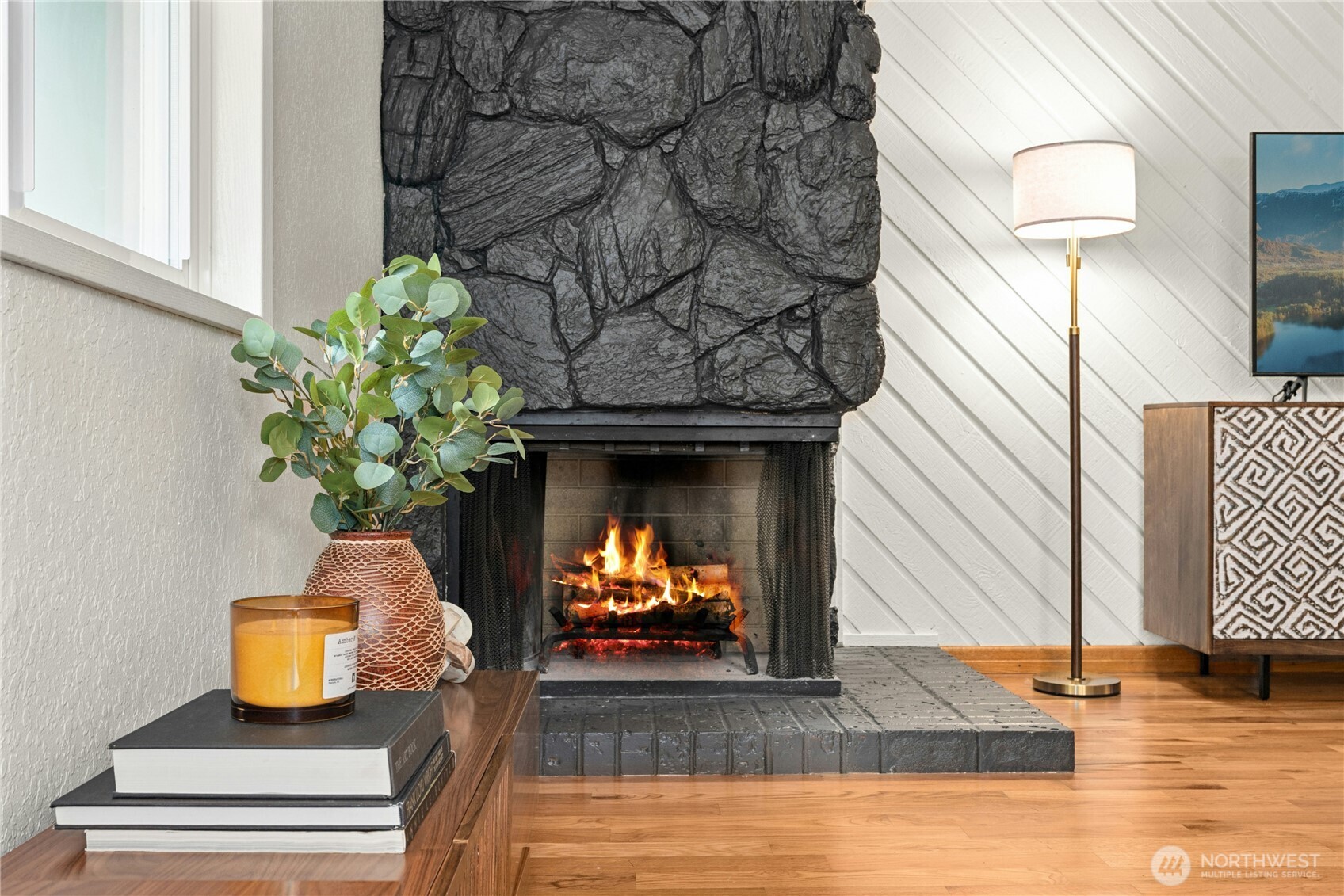 9523 Northeast 180th Street, Unit A102 Bothell, WA 98011 - Photo 6 of 29 a living room with furniture and a fireplace