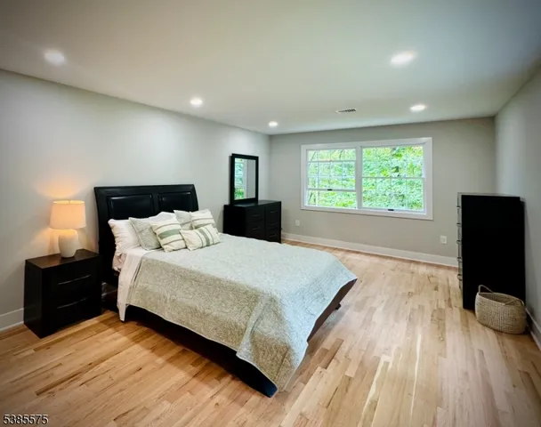 a spacious bedroom with a bed and a large window