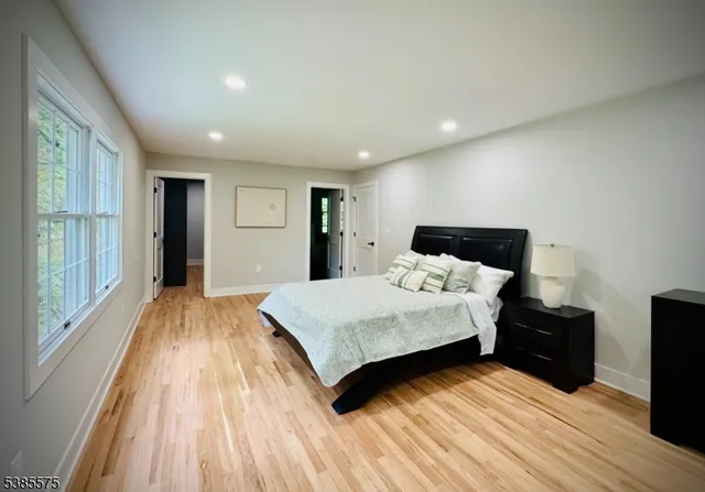 a bathroom with a double vanity sink mirror and bathtub