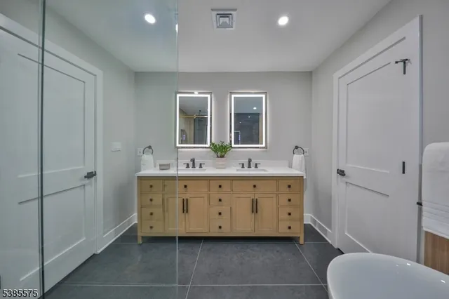 a living room with furniture a large window and kitchen view