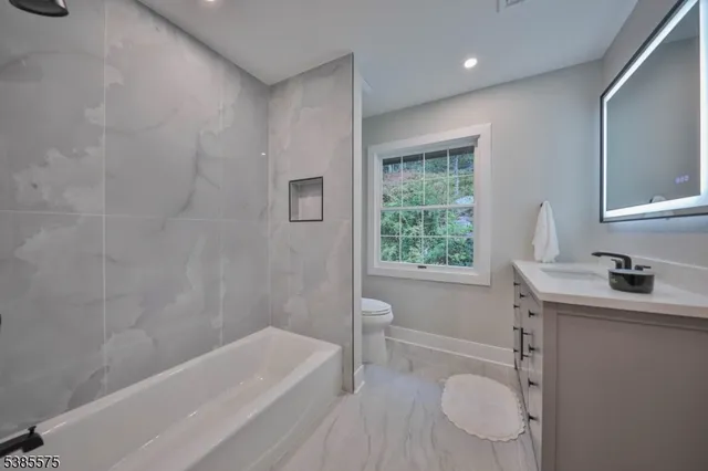 a bathroom with a sink toilet and vanity