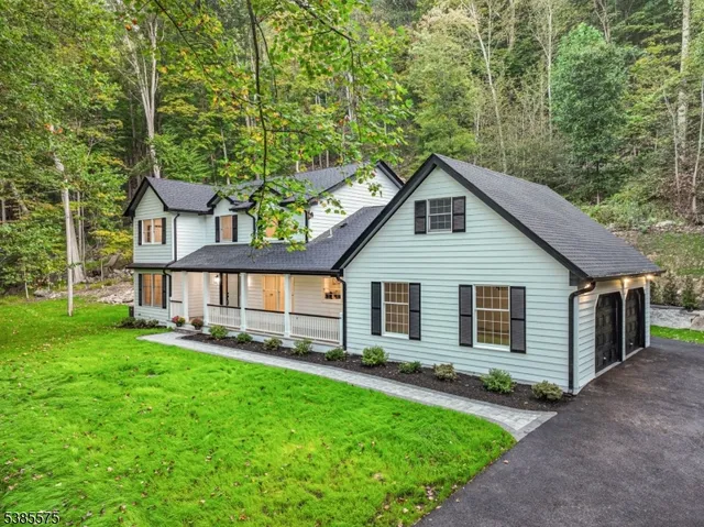 a view of a house with a yard and sitting area