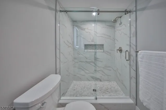 a bathroom with a shower toilet and sink