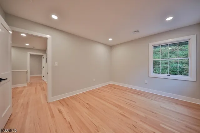 an empty room with a empty space and windows