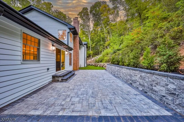 a view of a house with a yard and large tree