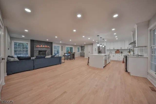 a view of kitchen with kitchen island white cabinets and refrigerator