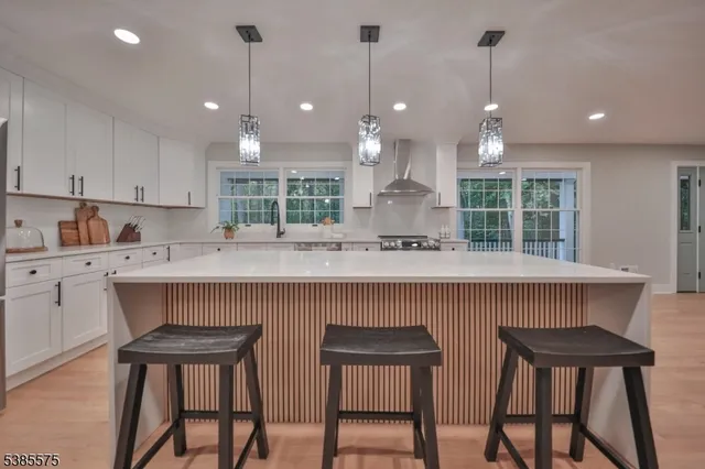 a kitchen with a table chairs sink and cabinets