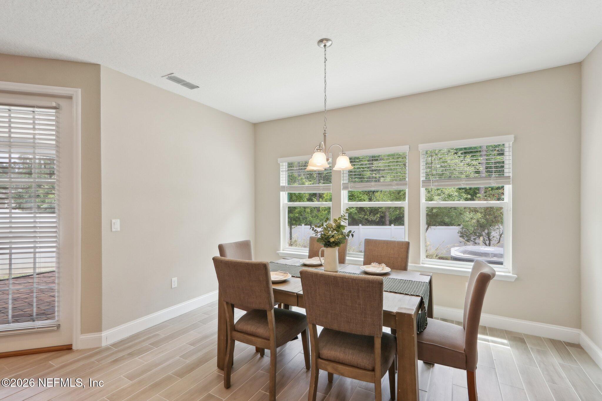 367 Sweet Oak Way St. Augustine, FL 32095 - Photo 11 of 51 a view of a dining room with furniture window and wooden floor