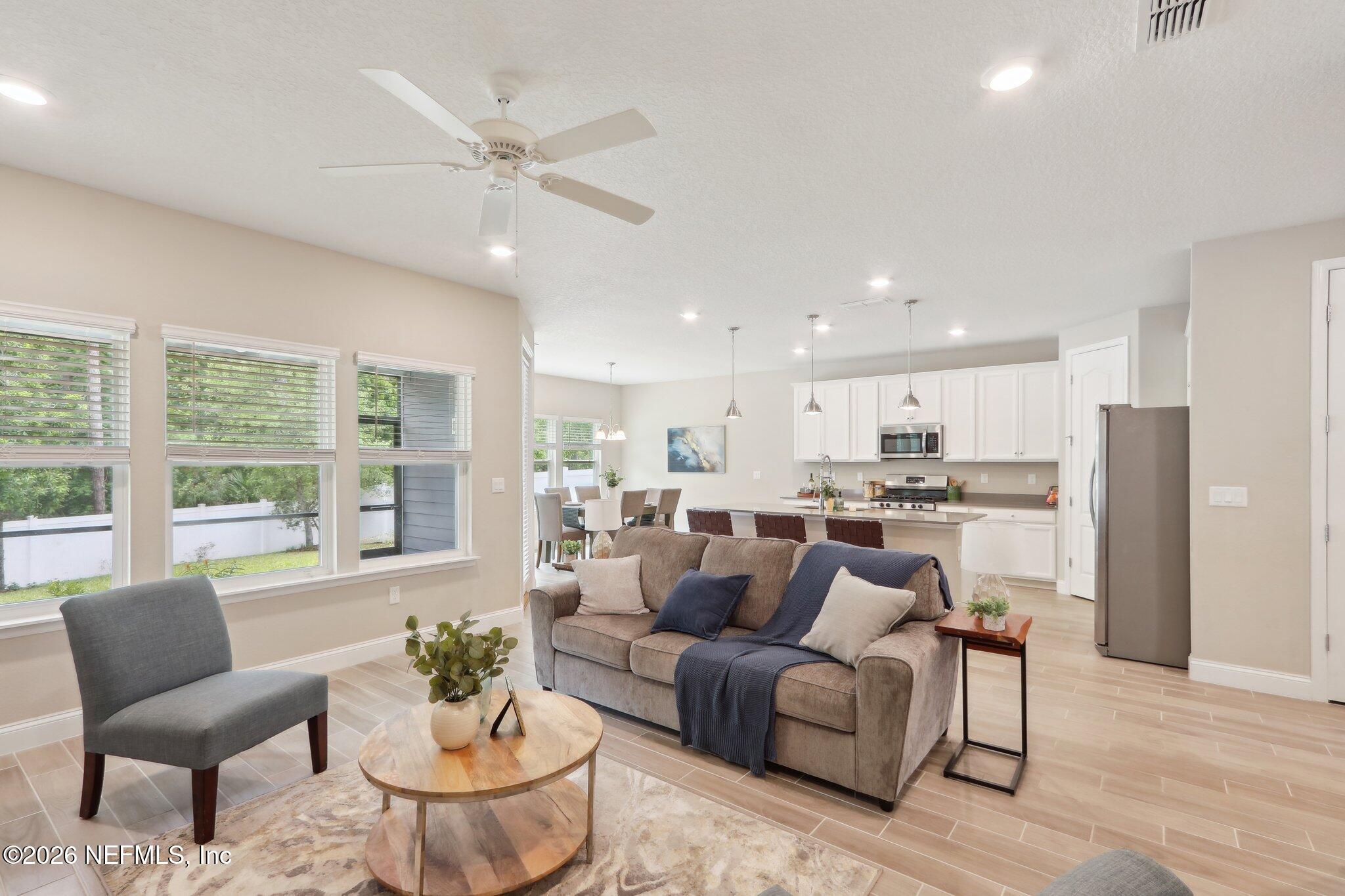 367 Sweet Oak Way St. Augustine, FL 32095 - Photo 9 of 51 a living room with furniture and a large window with kitchen view