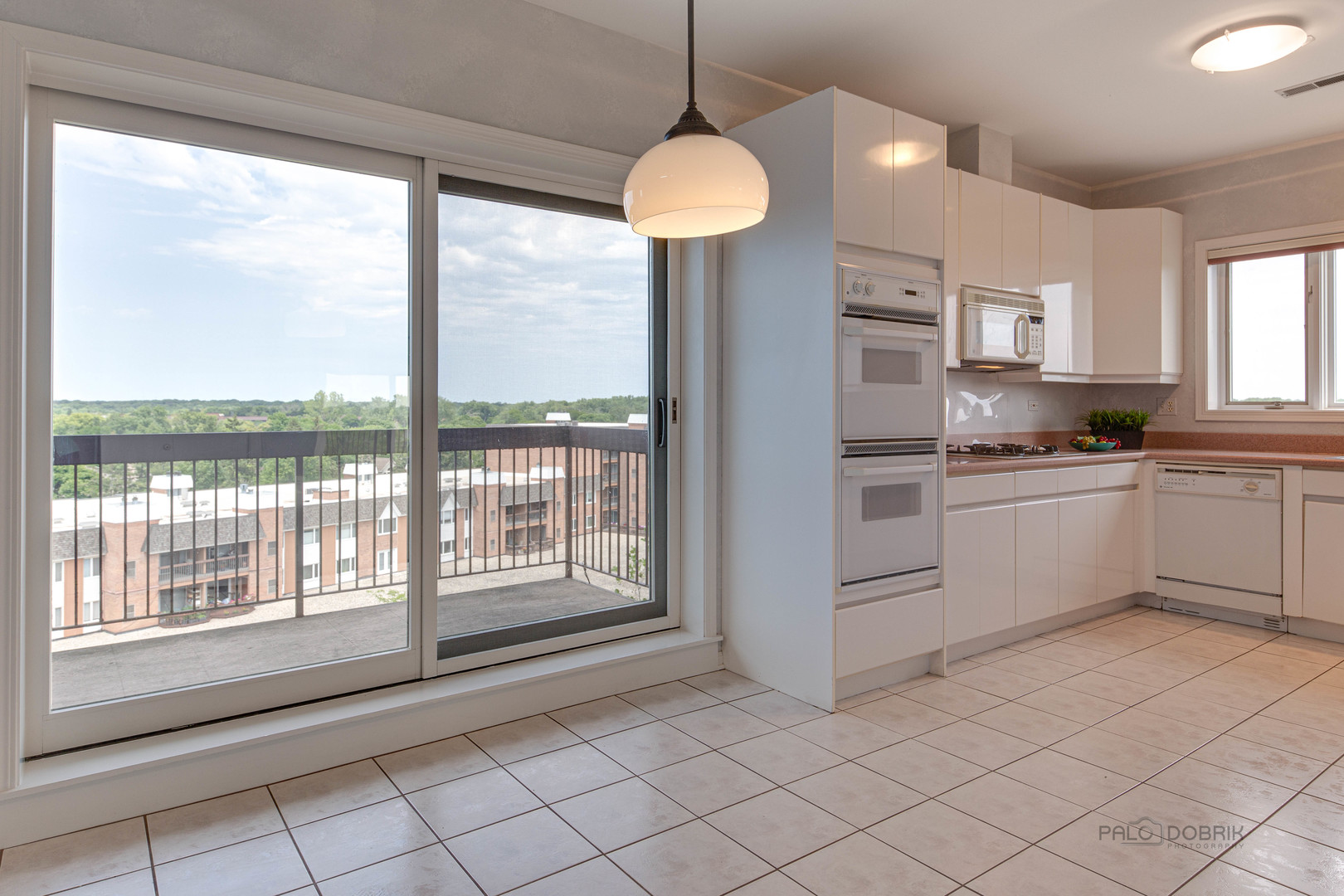 211 Rivershire Lane, Unit 602 Lincolnshire, IL 60069 - Photo 12 of 38 a kitchen with white cabinets and a sink