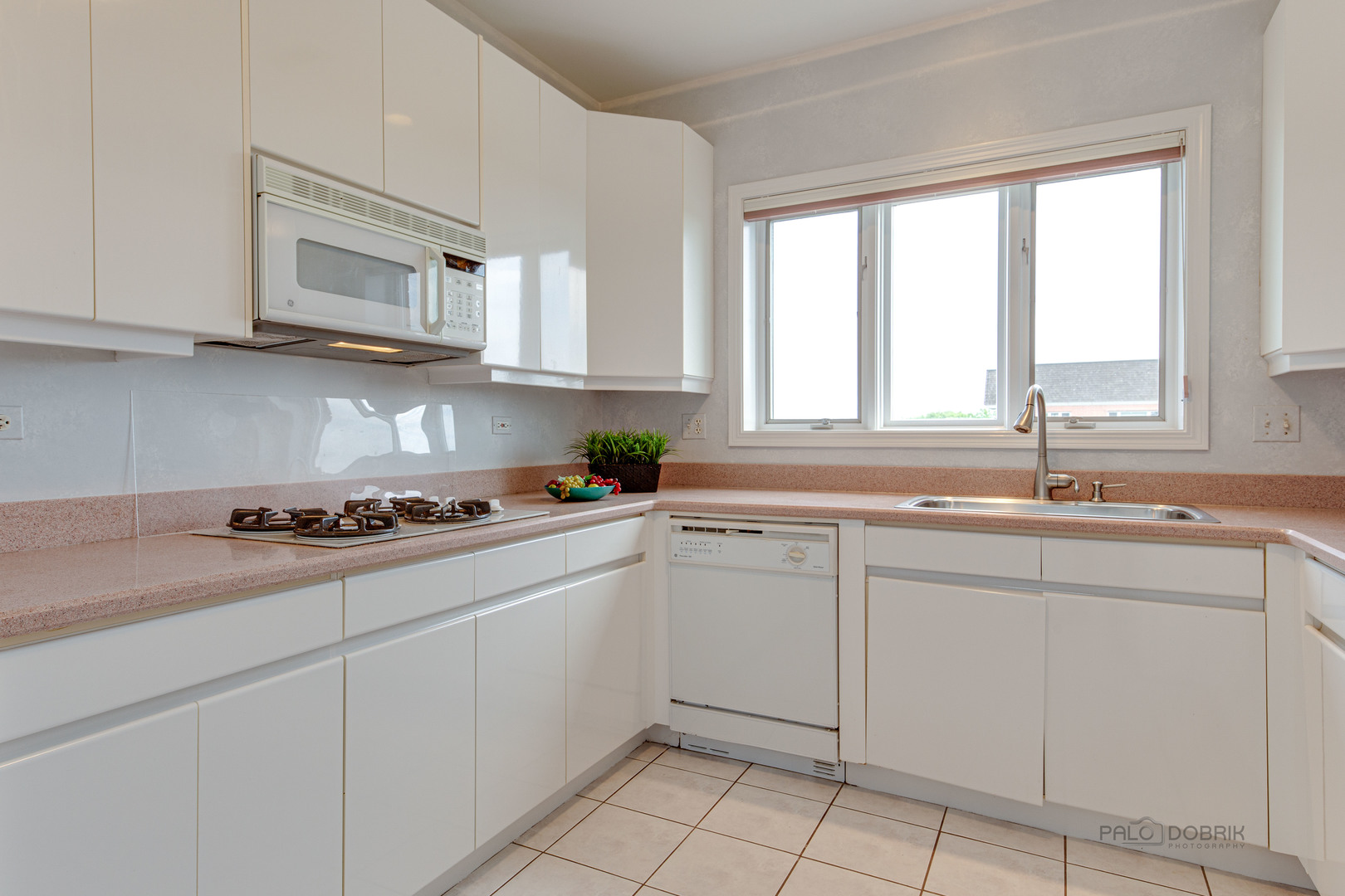 211 Rivershire Lane, Unit 602 Lincolnshire, IL 60069 - Photo 13 of 38 a kitchen with cabinets appliances a sink and a window