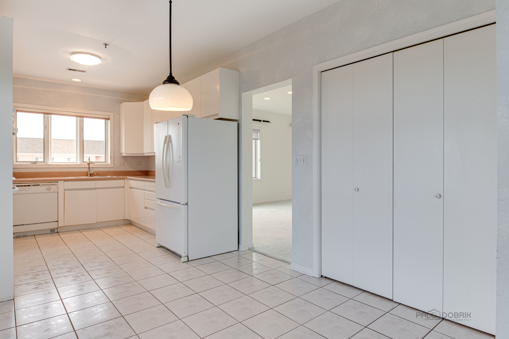 211 Rivershire Lane, Unit 602 Lincolnshire, IL 60069 - Photo 14 of 38 a kitchen with white cabinets and white appliances