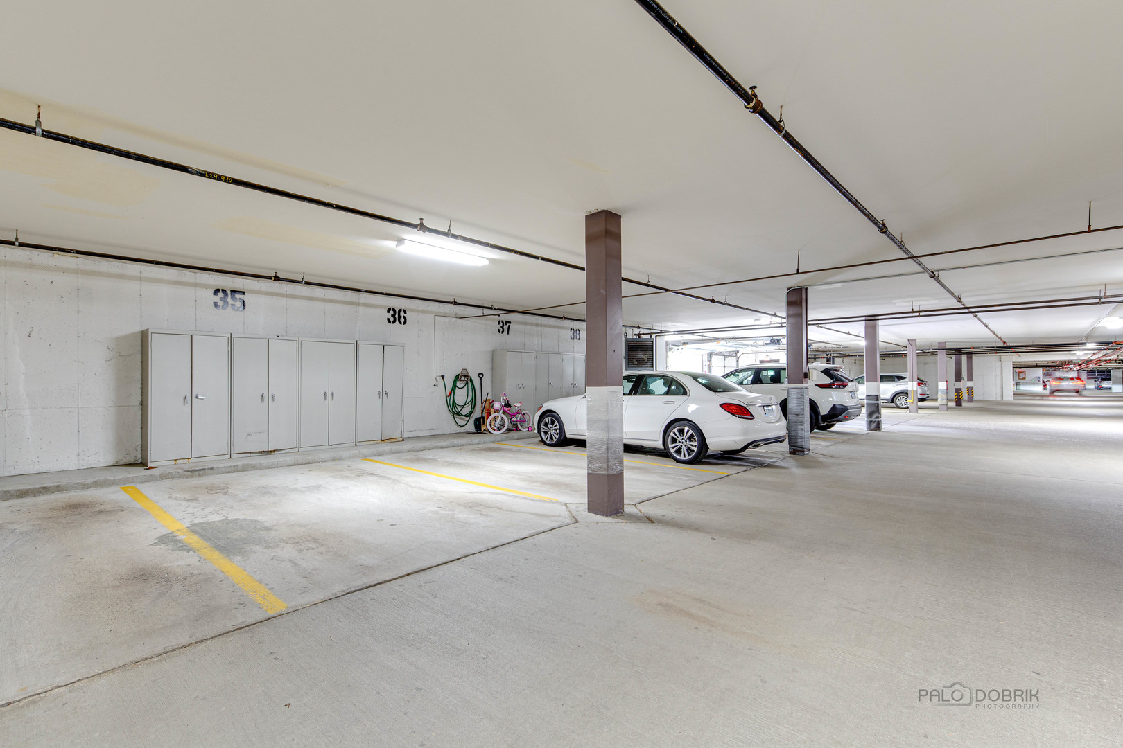 211 Rivershire Lane, Unit 602 Lincolnshire, IL 60069 - Photo 26 of 38 a view of parking garage with cars
