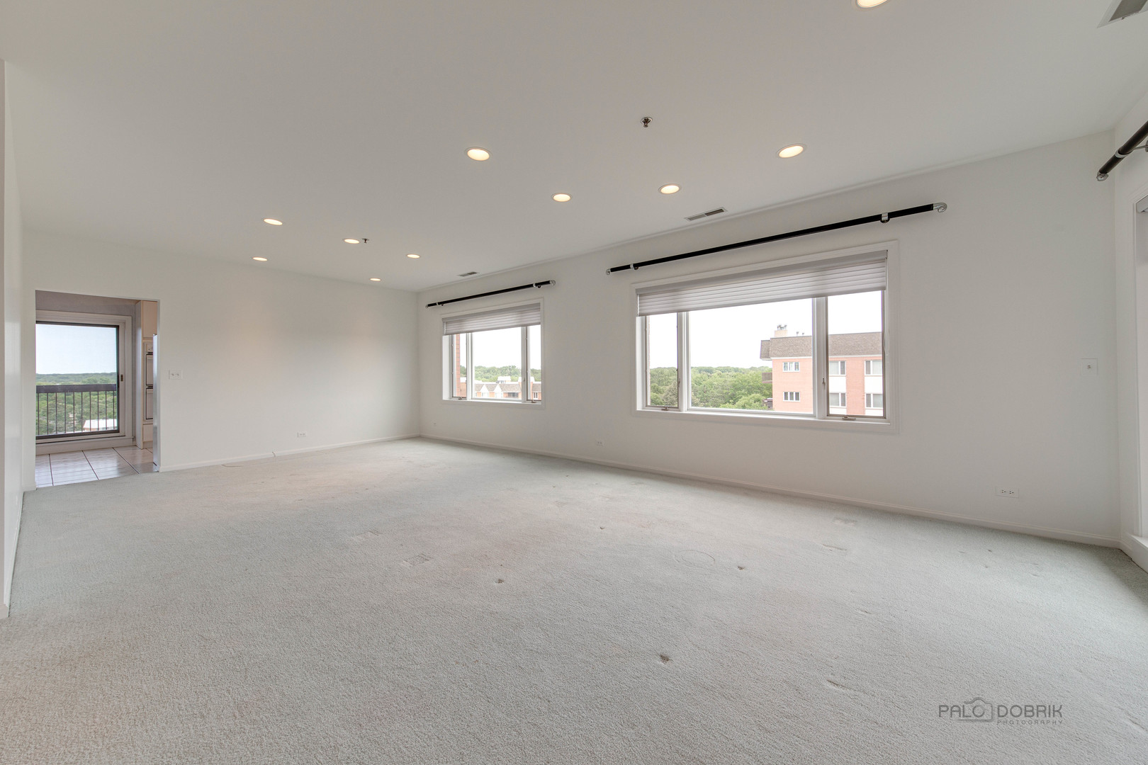211 Rivershire Lane, Unit 602 Lincolnshire, IL 60069 - Photo 5 of 38 an empty room with windows