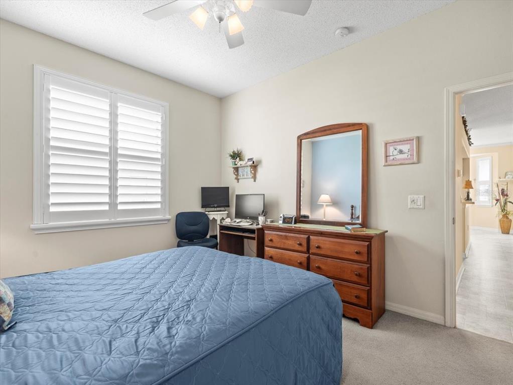 18514 Hidden Pines Way Hudson, FL 34667 - Photo 32 of 57 a bedroom with a bed and a dresser