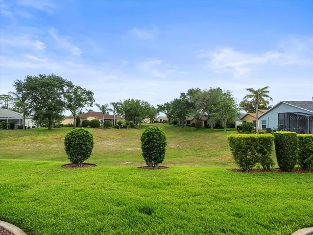 an aerial view of residential houses with outdoor space and swimming pool