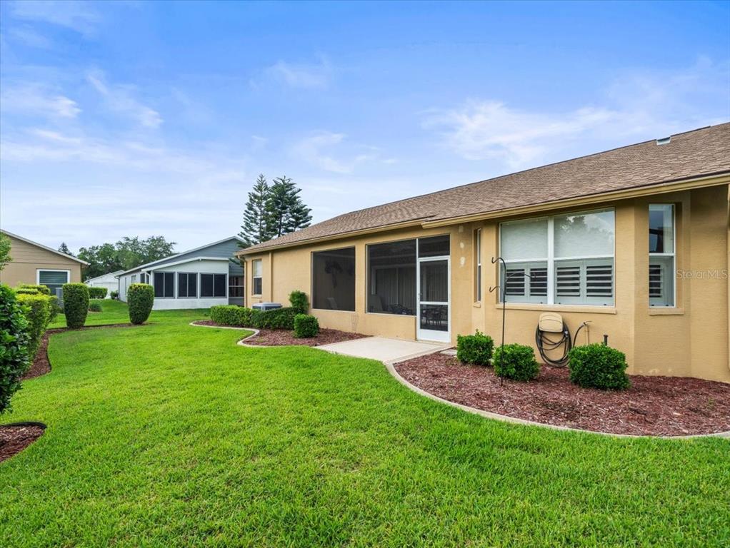 18514 Hidden Pines Way Hudson, FL 34667 - Photo 42 of 57 a front view of a house with a yard and porch