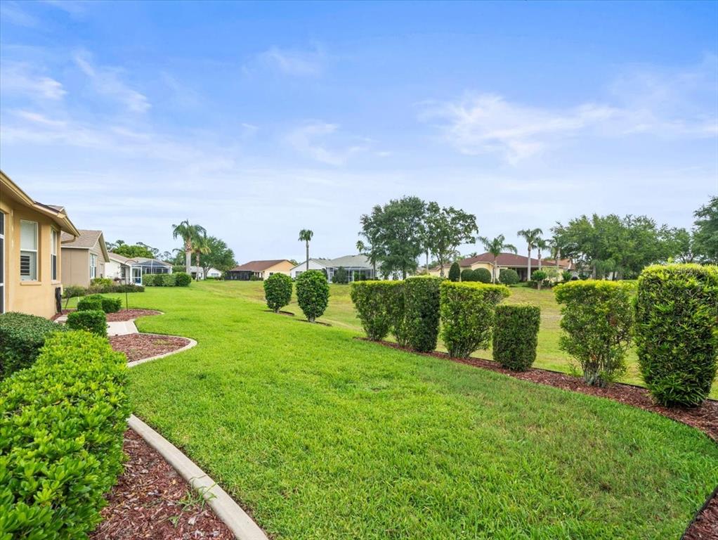 18514 Hidden Pines Way Hudson, FL 34667 - Photo 43 of 57 a view of a garden with a building in the background