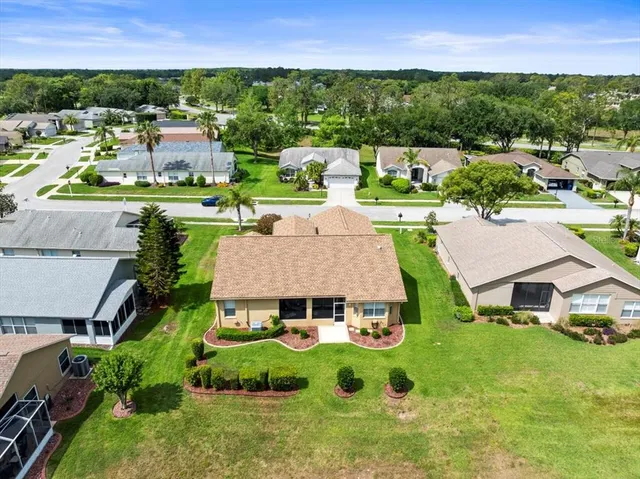 an aerial view of residential houses with outdoor space