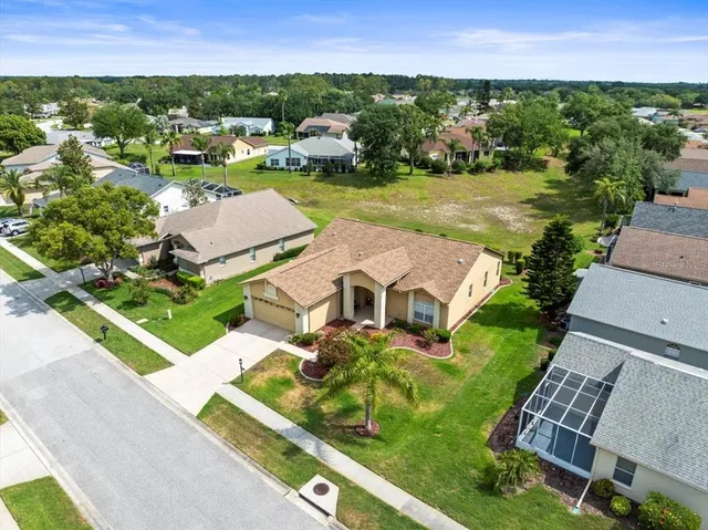 an aerial view of a residential houses with outdoor space and river