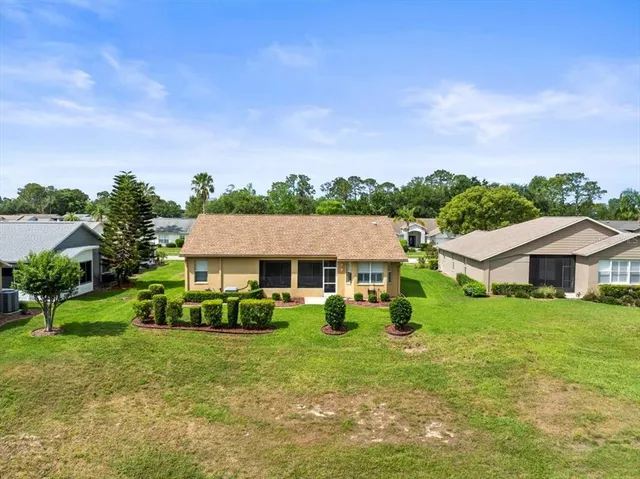 an aerial view of residential houses with outdoor space and street view