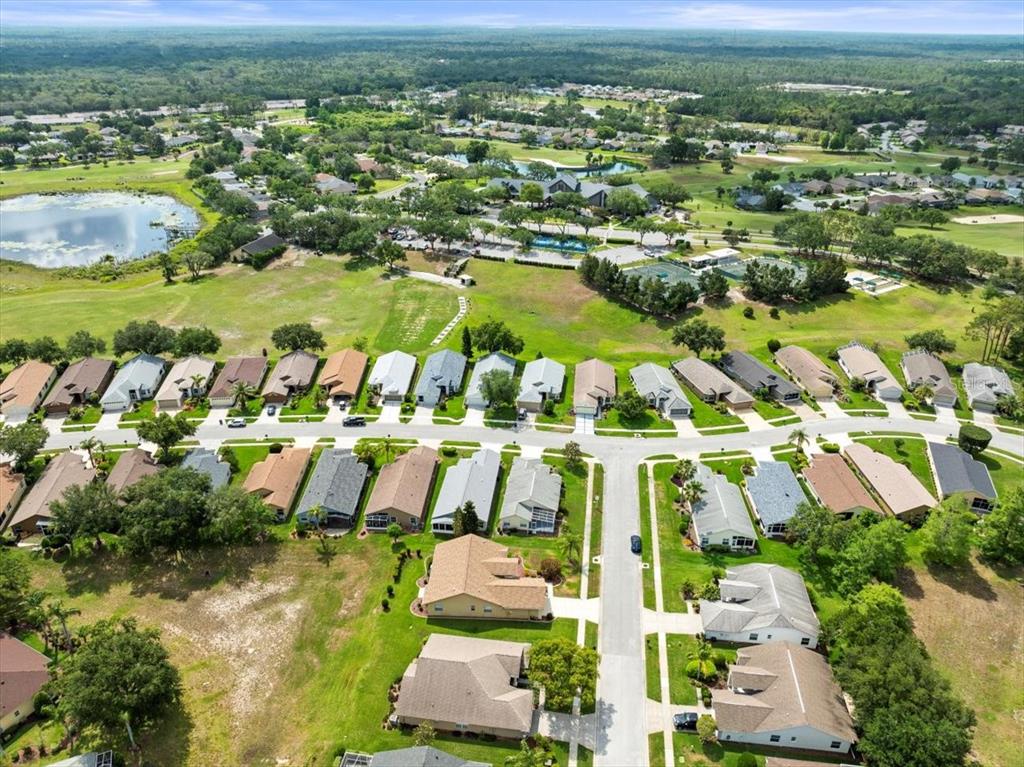 18514 Hidden Pines Way Hudson, FL 34667 - Photo 50 of 57 an aerial view of residential houses with outdoor space