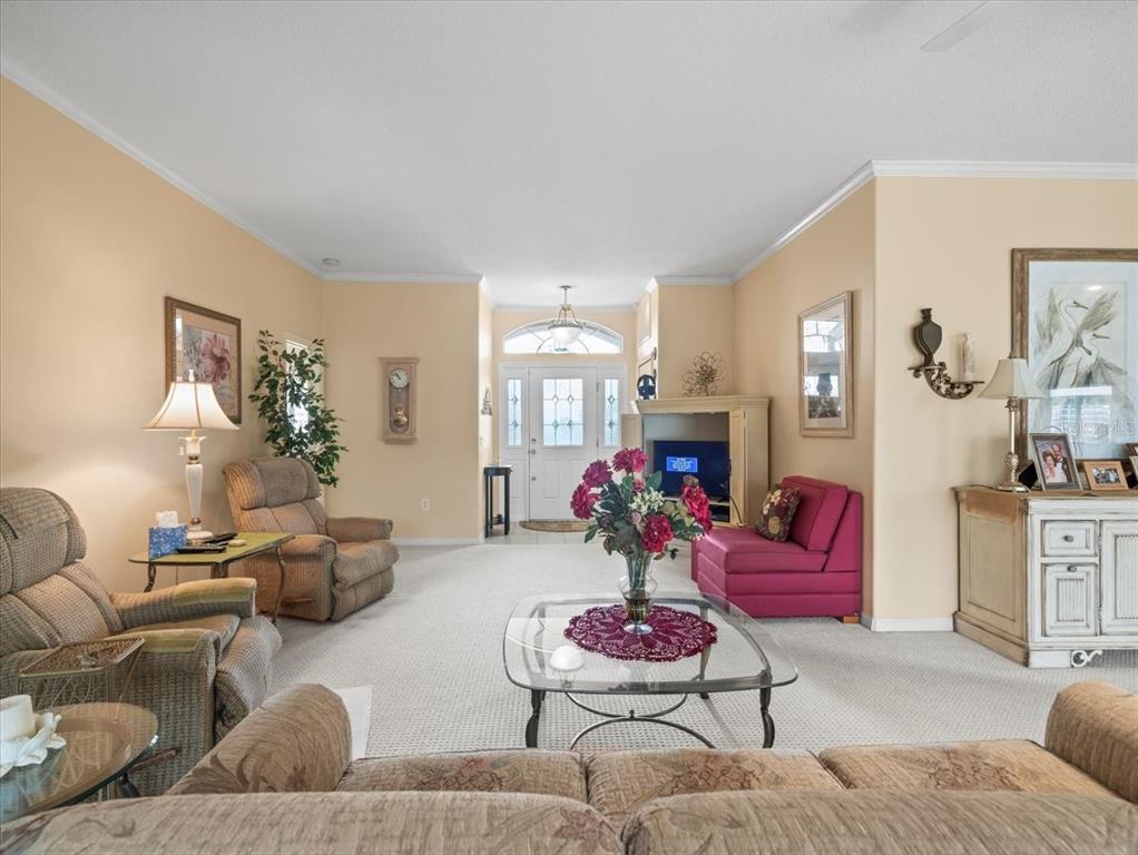 18514 Hidden Pines Way Hudson, FL 34667 - Photo 6 of 57 a living room with furniture kitchen and a fireplace