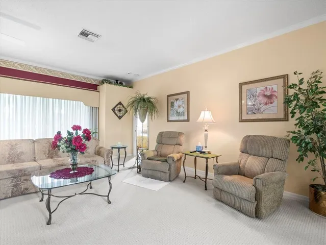 a living room with furniture and flowers