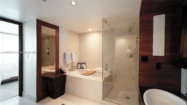 a bathroom with a bathtub shower sink vanity and toilet