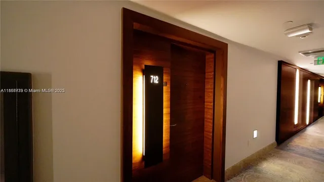 a front view of a multi story building with a palm trees