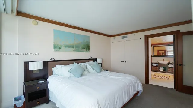 a bedroom with a bed and a night stand