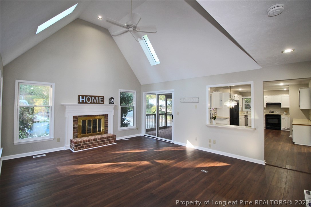 297 Fieldcrest Road Southern Pines, NC 28387 - Photo 5 of 32 an empty room with windows and fireplace