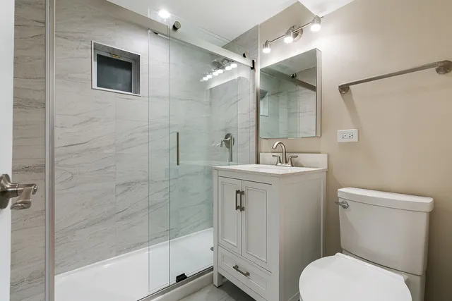 a bathroom with a toilet sink and shower