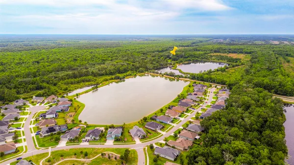an aerial view of residential houses with outdoor space